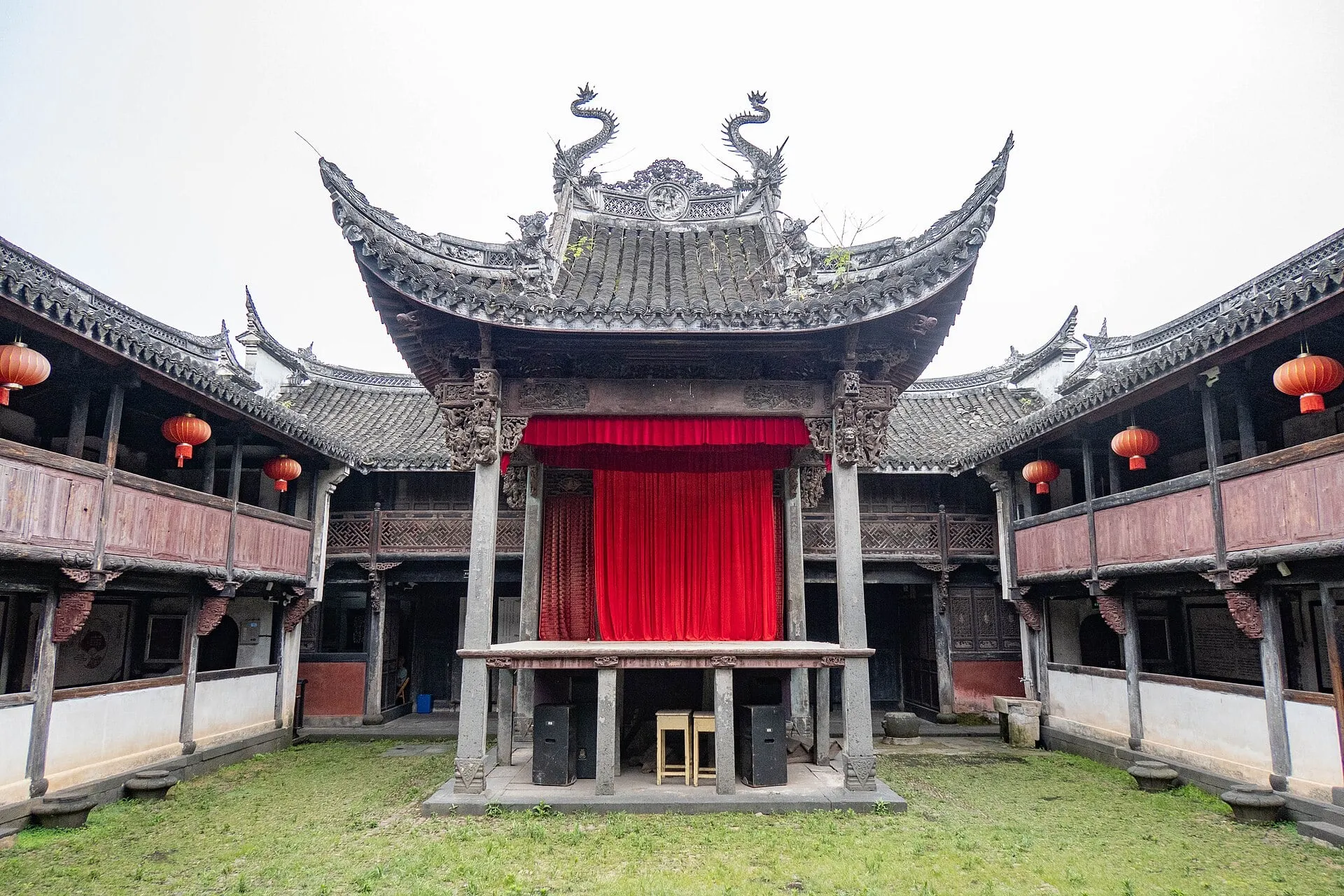 The old stage in the Yushan Ancestral Hall, flanked by two-story galleries.